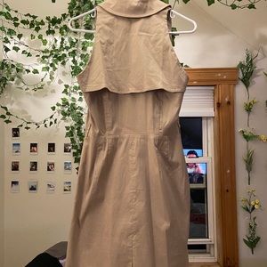 Tan trench coat style dress. Has pockets and zips up the side.
